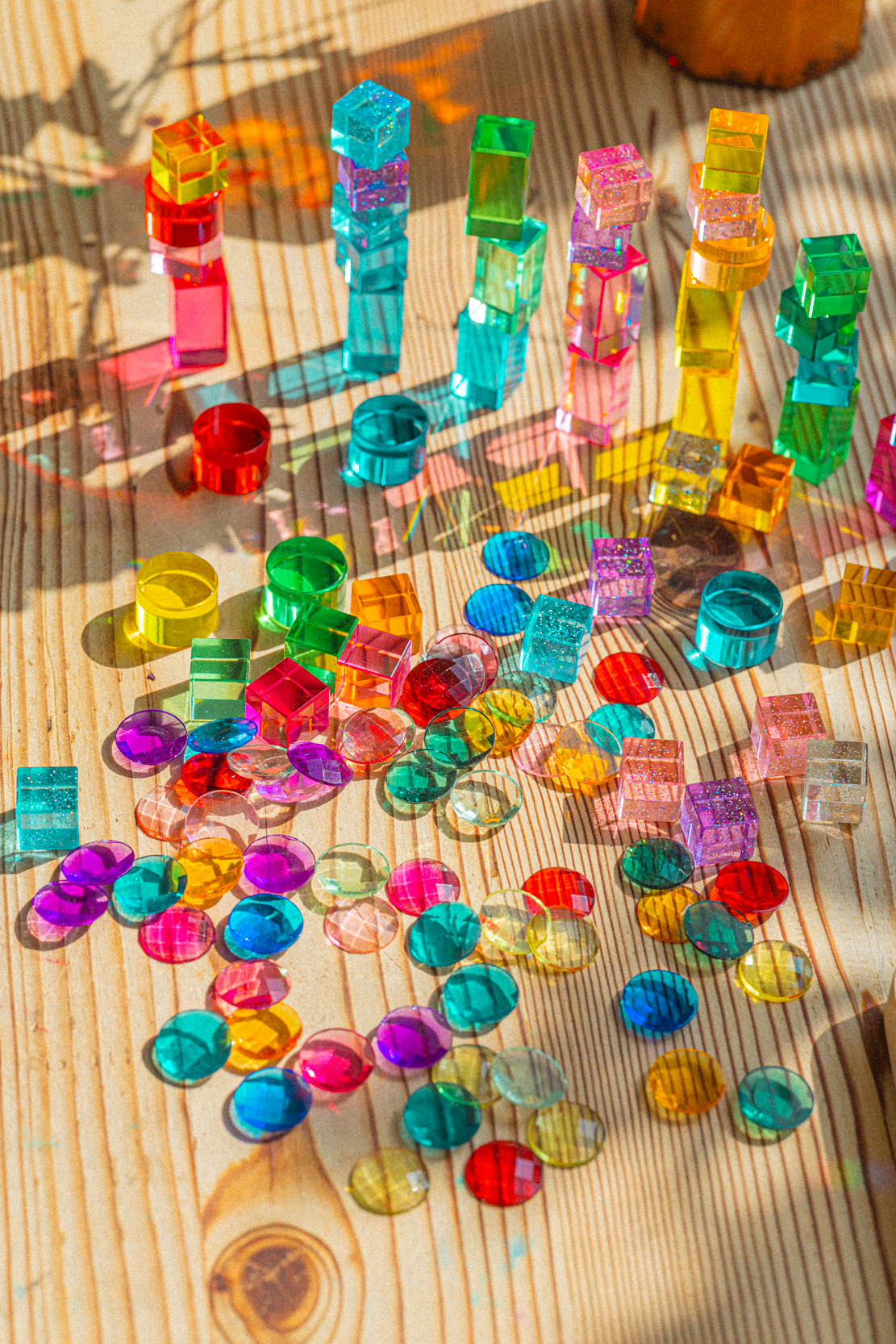 Colorful gem blocks glowing in a patch of sunlight — photo by Kathy